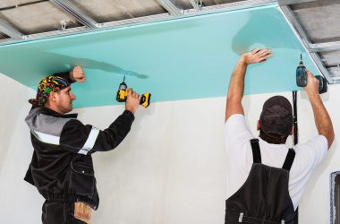 plasterboard installers. men assembling a drywall false ceiling.simple and affordable renovation of premises plasterboard installers. men assembling a drywall false ceiling.simple and affordable renovation of premises
